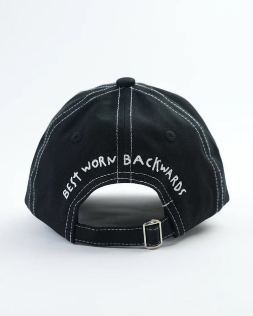 Best Worn Backwards Cap  on flat lay - black cap with white stitching red logo black eyelets