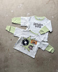 Children's long sleeve front  design that reads 'boogie bug' and back with graphic design on a concrete floor.